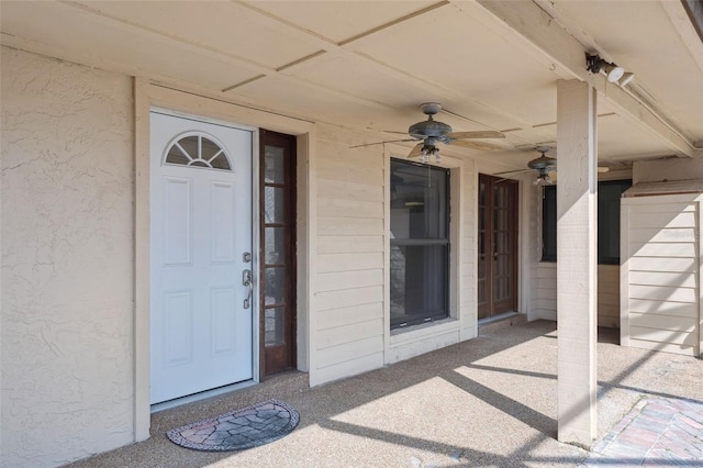 view of exterior entry featuring ceiling fan