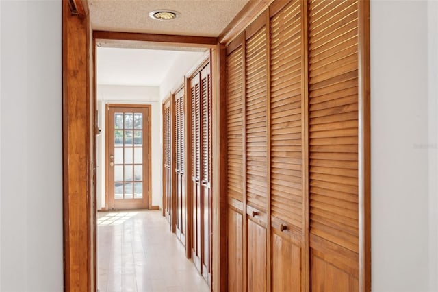 hallway featuring a textured ceiling