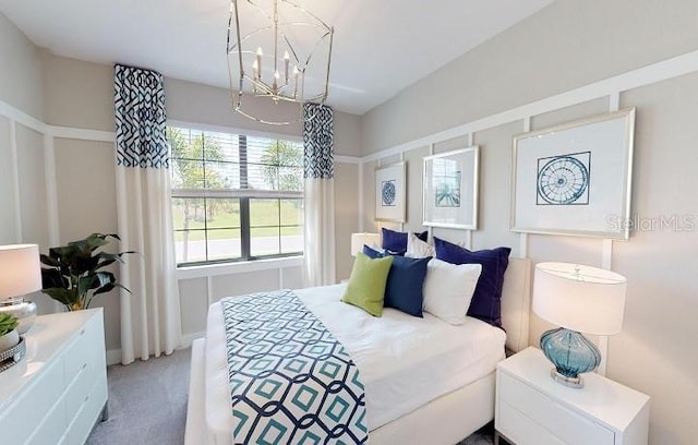 carpeted bedroom featuring a chandelier