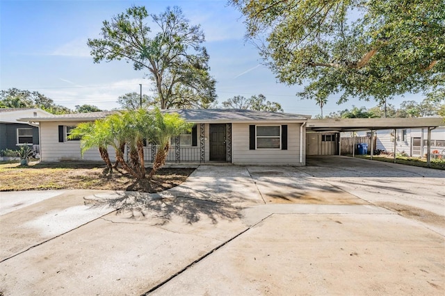 ranch-style house featuring a carport