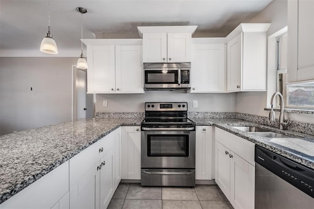 kitchen with pendant lighting, sink, white cabinetry, stainless steel appliances, and light stone counters