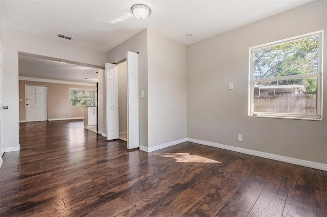 unfurnished room featuring dark wood-type flooring