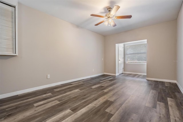 empty room featuring dark wood-type flooring and ceiling fan