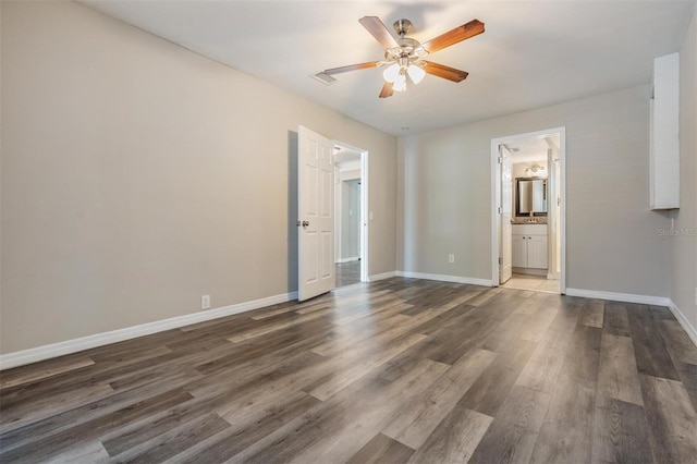 spare room with dark hardwood / wood-style floors and ceiling fan