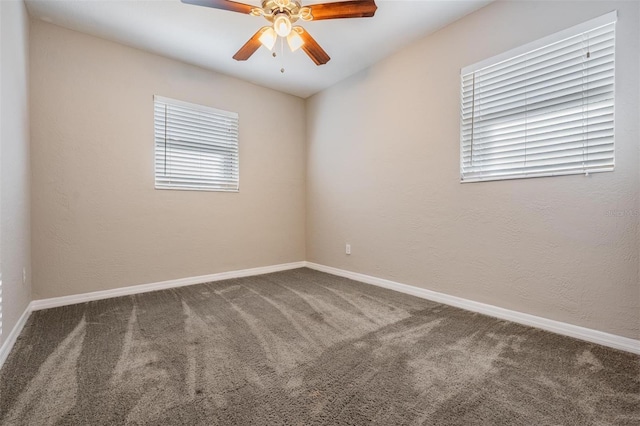 carpeted spare room with ceiling fan