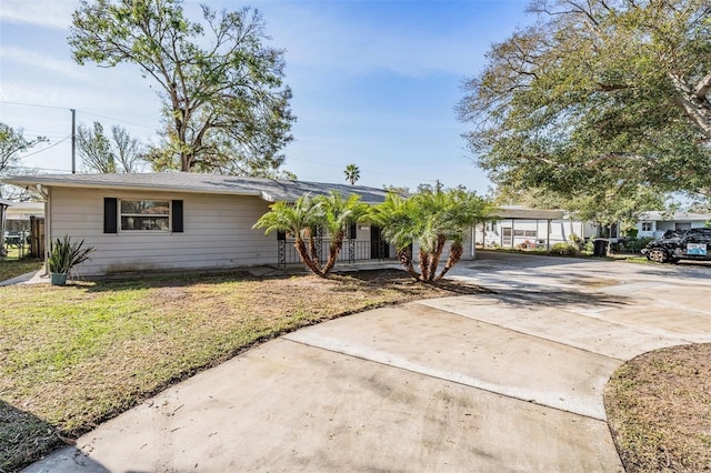 ranch-style house featuring a carport and a front yard