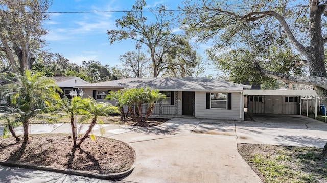 ranch-style home with a carport and covered porch