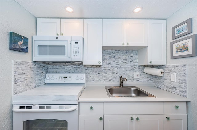 kitchen with white cabinetry, white appliances, sink, and backsplash