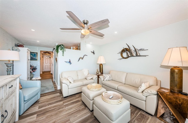 living room with ceiling fan and hardwood / wood-style floors