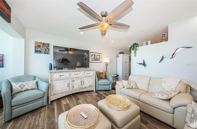 living room featuring dark hardwood / wood-style flooring and ceiling fan