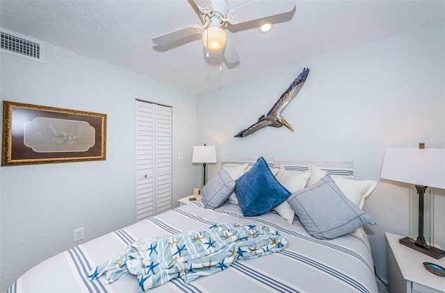 bedroom with ceiling fan, a closet, and a textured ceiling