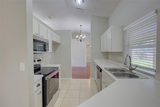 kitchen featuring white cabinetry, appliances with stainless steel finishes, sink, and hanging light fixtures