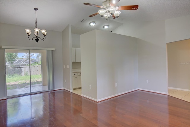 interior space featuring ceiling fan with notable chandelier, a textured ceiling, and light hardwood / wood-style floors