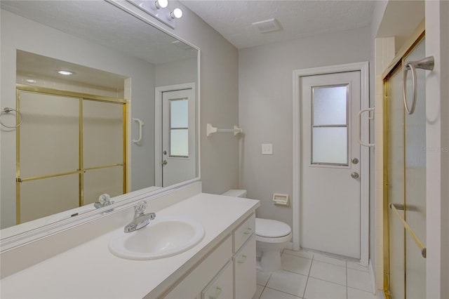 bathroom featuring tile patterned flooring, vanity, an enclosed shower, and a textured ceiling