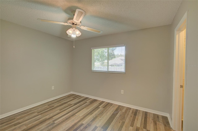 spare room with ceiling fan, wood-type flooring, and a textured ceiling