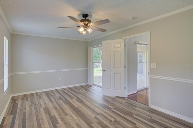 empty room with crown molding, ceiling fan, hardwood / wood-style floors, and a textured ceiling