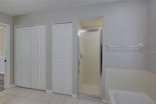 bathroom with plus walk in shower and tile patterned flooring