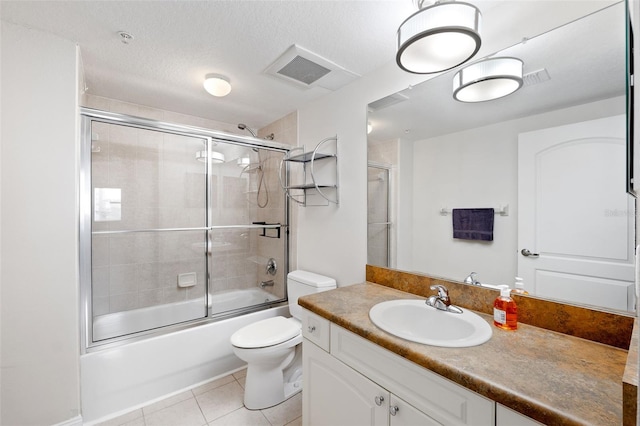 full bathroom with toilet, bath / shower combo with glass door, a textured ceiling, vanity, and tile patterned flooring