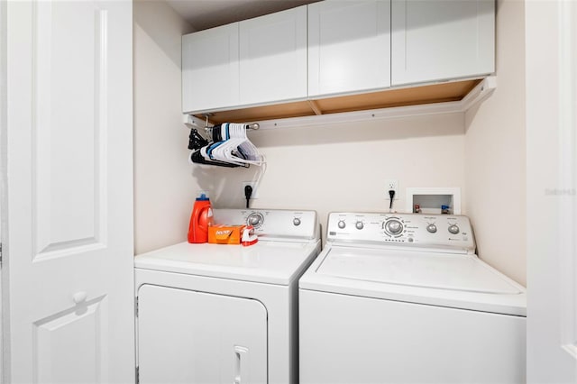 laundry area with cabinets and washer and clothes dryer