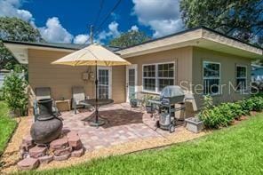 rear view of house with a yard and a patio area