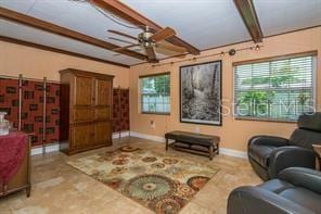 living room with ceiling fan and beam ceiling