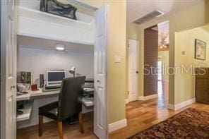 office area with hardwood / wood-style flooring