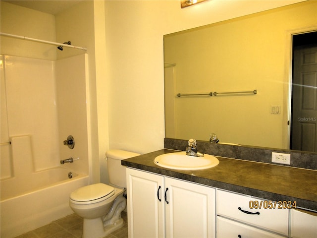 full bathroom with washtub / shower combination, vanity, toilet, and tile patterned flooring