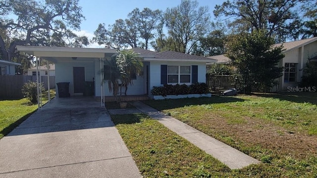 ranch-style home featuring a carport and a front yard