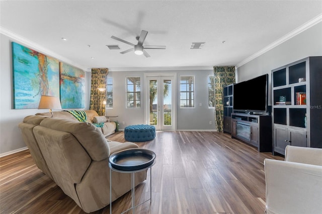 living room with crown molding, wood-type flooring, ceiling fan, and french doors