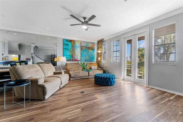 living room featuring crown molding, wood-type flooring, and ceiling fan