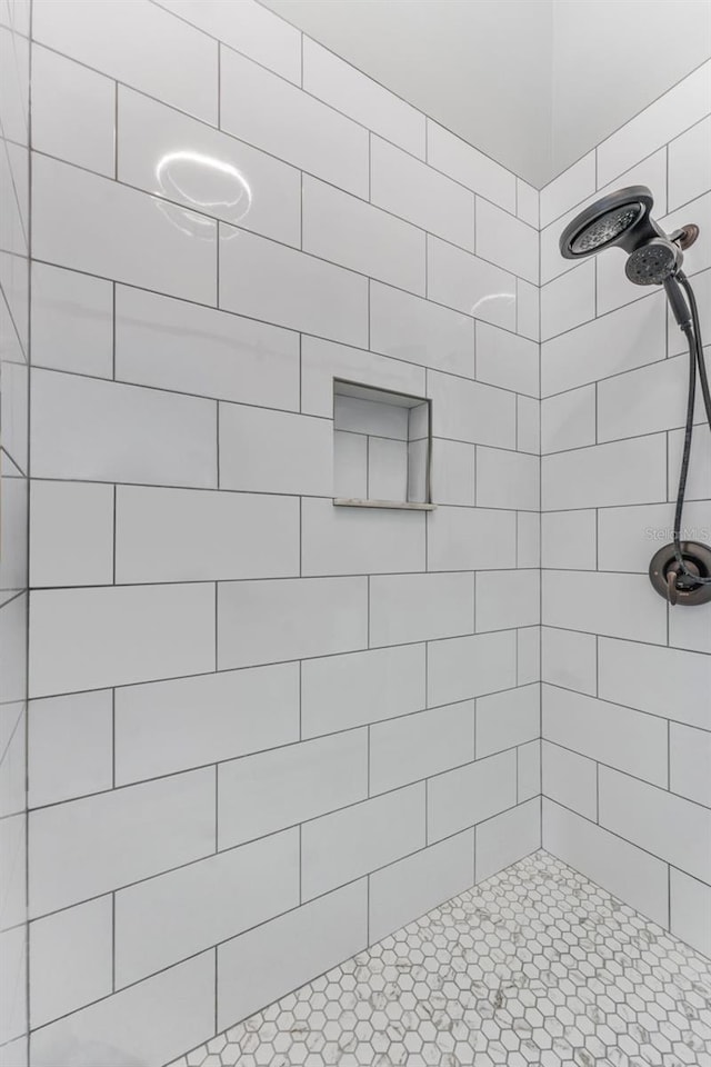 bathroom with tiled shower