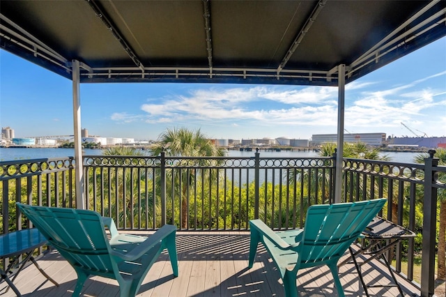 wooden terrace featuring a water view