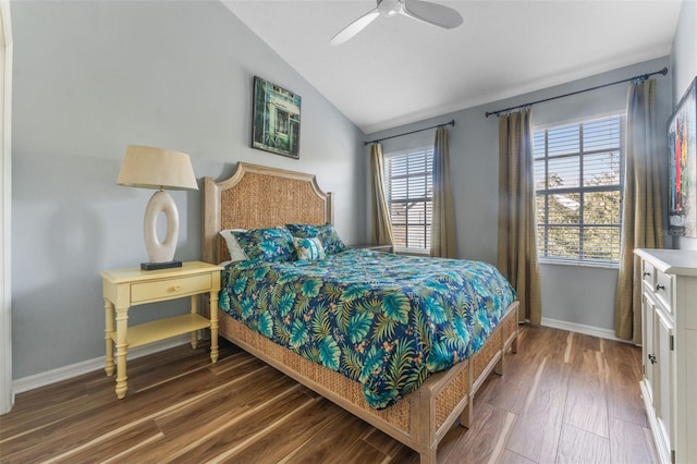 bedroom with lofted ceiling, dark hardwood / wood-style floors, and ceiling fan