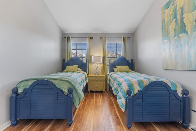 bedroom featuring wood-type flooring and lofted ceiling