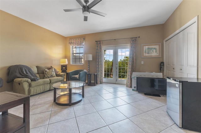 tiled living room featuring french doors and ceiling fan