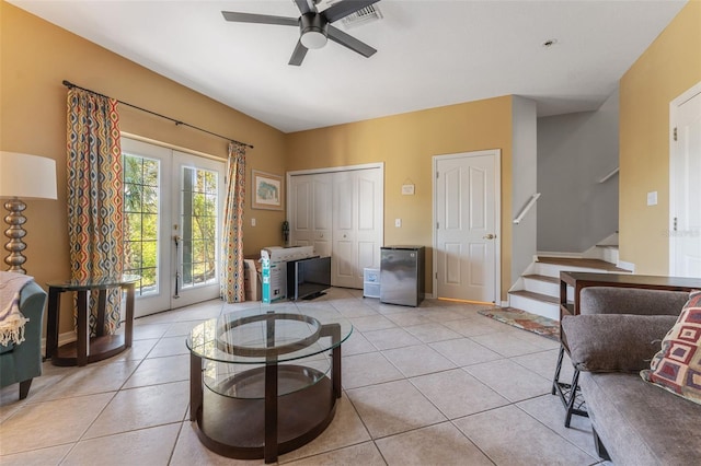 living area featuring light tile patterned flooring, ceiling fan, and french doors