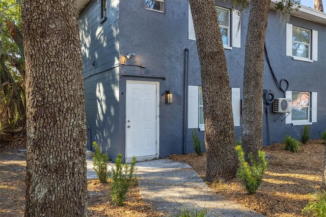 doorway to property featuring ac unit