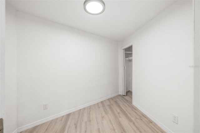 unfurnished bedroom with light hardwood / wood-style flooring and a closet