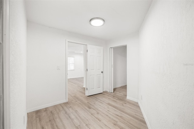 unfurnished room with light wood-type flooring