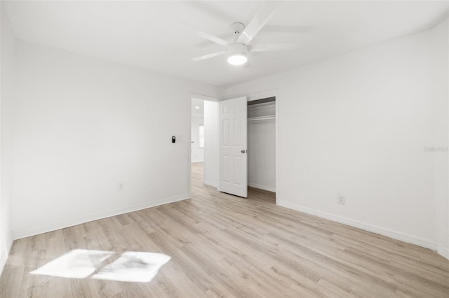 unfurnished bedroom featuring light hardwood / wood-style floors, a closet, and ceiling fan