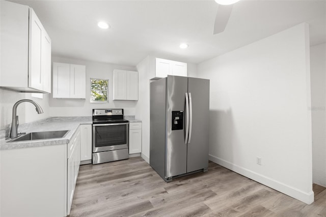 kitchen featuring white cabinetry, appliances with stainless steel finishes, sink, and light hardwood / wood-style floors