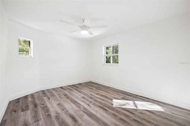 spare room featuring hardwood / wood-style flooring, plenty of natural light, and ceiling fan