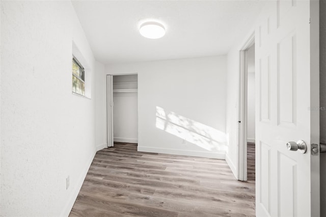 unfurnished bedroom featuring hardwood / wood-style flooring and a closet