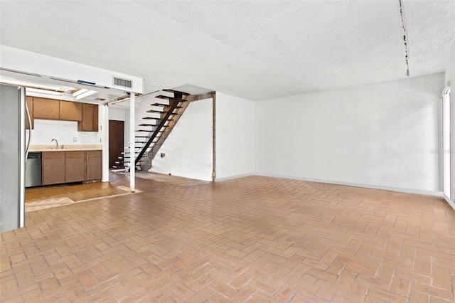 unfurnished living room with a textured ceiling