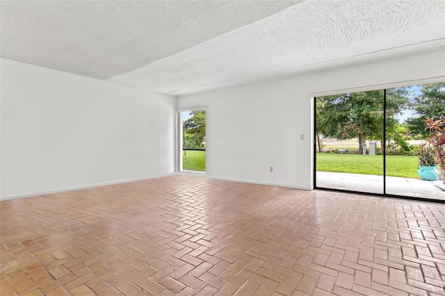 unfurnished room featuring a textured ceiling