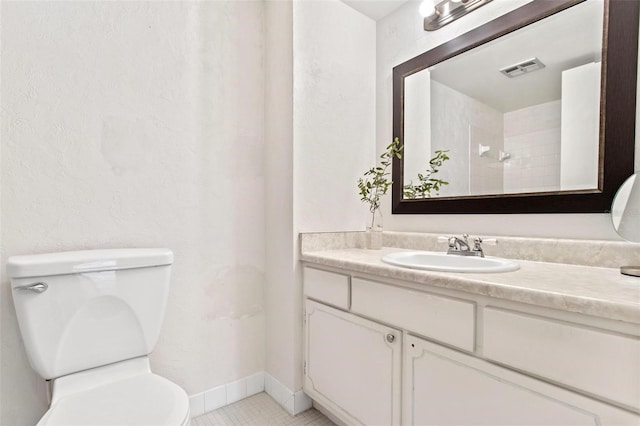 bathroom with vanity, toilet, and tile patterned flooring