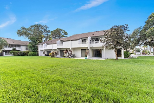 rear view of property with a yard