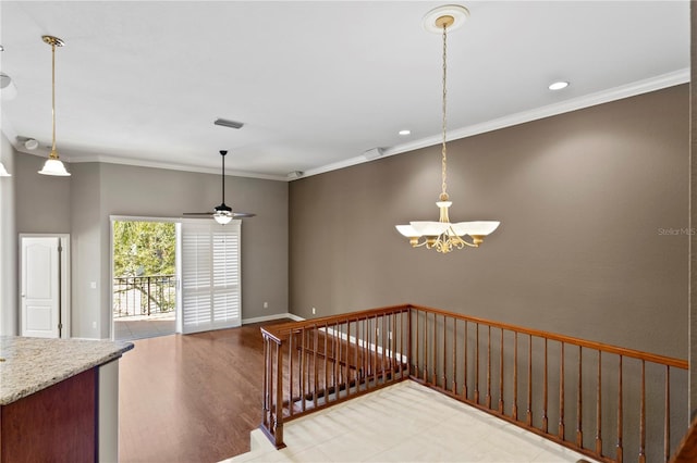 staircase featuring hardwood / wood-style floors, ceiling fan with notable chandelier, and ornamental molding