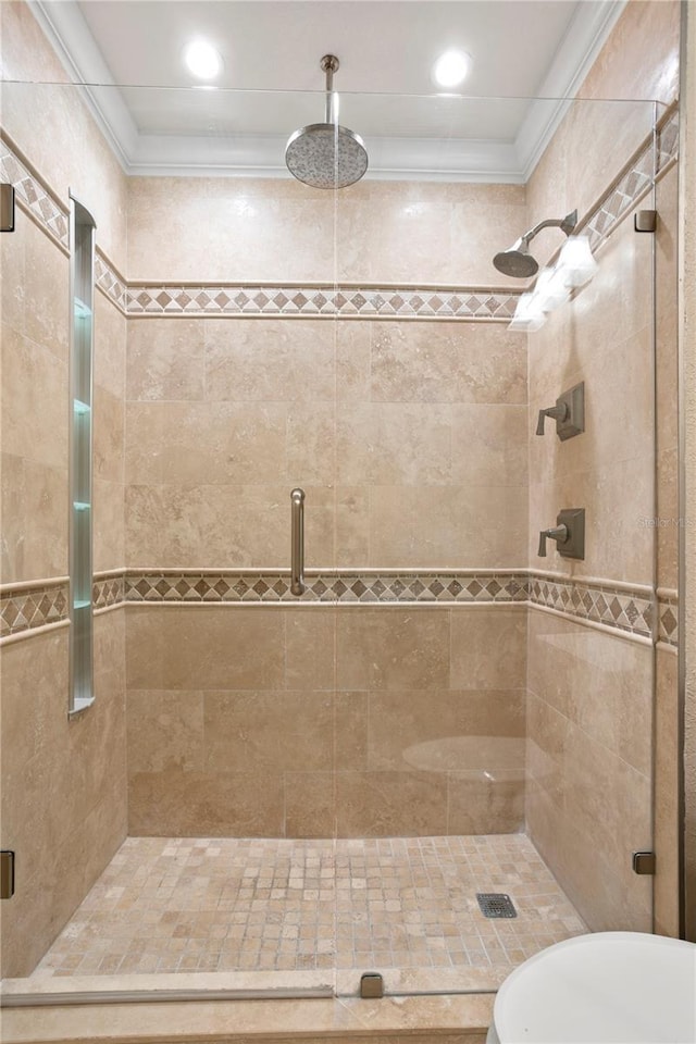 bathroom featuring crown molding and walk in shower