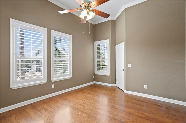 unfurnished room featuring hardwood / wood-style floors, crown molding, and ceiling fan